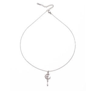 Silver star and crescent moon tassel necklace with sparkling crystals on white background