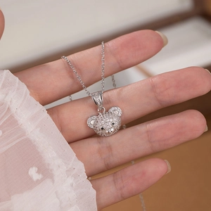 Close-up of a bear pendant necklace with white zircons and black gemstone eyes