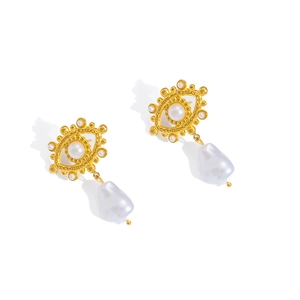 Detail of gold evil eye stud earrings featuring baroque pearls and white pearl centers