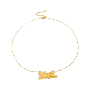 Detail view of a gold wing pendant necklace with central white pearl and lobster clasp