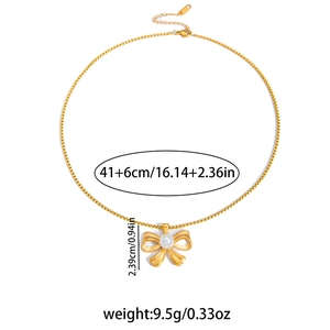 Close-up of golden bow pendant with white pearl on 41cm stainless steel chain