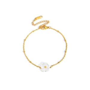 Detail of gold stainless steel link bracelet with white rose charm and lobster clasp