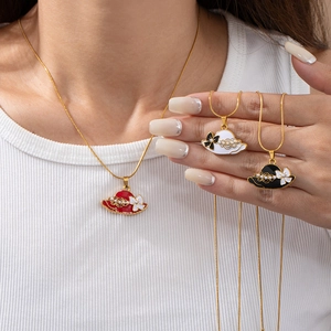 Minimalist stainless steel necklace featuring a creative hat pendant with pearls and bow