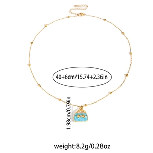 Detail showing gold pearl chain with blue handbag pendant and size specifications