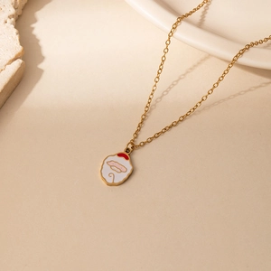 Detail of a golden stainless steel chain featuring a festive red and white cartoon elk pendant