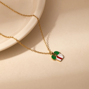 Detail of Christmas reindeer pendant necklace featuring enamel colors on a gold chain