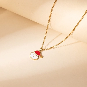Close-up of golden Christmas necklace with red and white enamel Santa Claus pendant