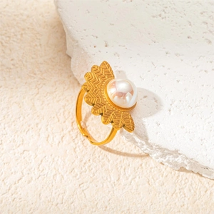 Detailed view of a vintage gold-plated ring with a fan-shaped design and a white pearl