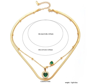 Detailed view of gold-layered butterfly necklace with green heart pendants and zircons
