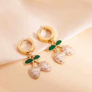 Close-up of gold double strawberry earrings with marble white fruit and green leaves