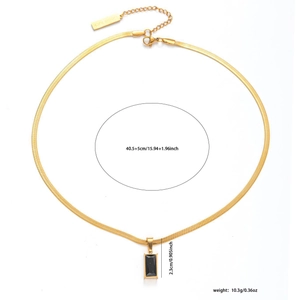 Golden snake chain necklace featuring a black gemstone pendant and 'Good luck' tag detail