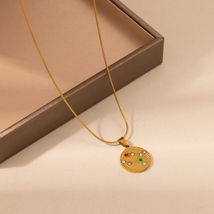 Detailed close-up of gold star constellation pendant with colorful crystals on snake chain