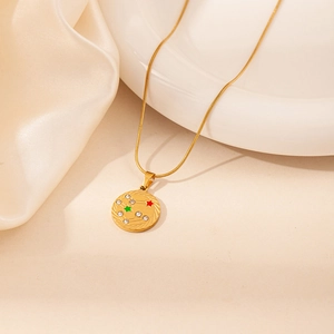 Detailed close-up of a gold zodiac pendant with zircon stones and star enamel details