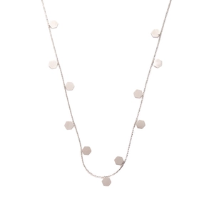Detailed macro view of minimalist silver stainless steel necklace with hexagonal charms