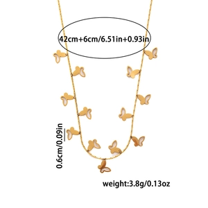 Detail view of a gold stainless steel necklace featuring delicate hollow butterfly pendants