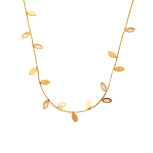 Detailed macro of golden necklace featuring matte solid and hollow leaf pendants