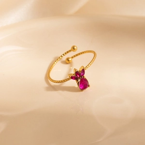 Golden titanium steel ring featuring pink crown-shaped zircon crystals on textured band