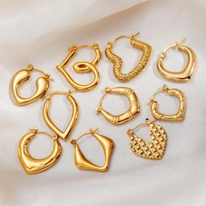 Collection of gold titanium steel earrings with heart and geometric twist designs