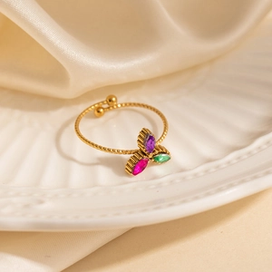 Gold stainless steel open ring with colorful zircon petals on champagne silk background