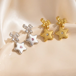Boucles d'oreilles nœud et étoile en or et argent avec incrustations de pierres rondes