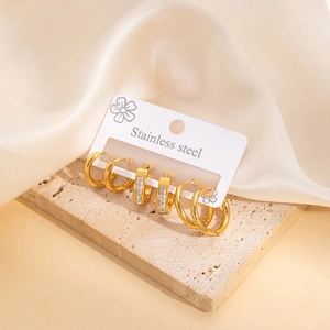 Three pairs of gold stainless steel hoop earrings including rectangular zircon studs