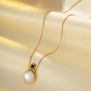 18k gold-plated cat eye stone necklace with green crystal on elegant silk background