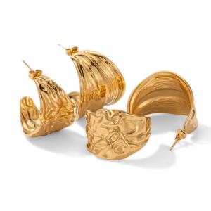 Golden chunky C-shape hoop earrings with irregular hammered texture on white background