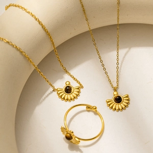 Gold stainless steel jewelry set featuring sunburst fan pendants and tiger eye stones