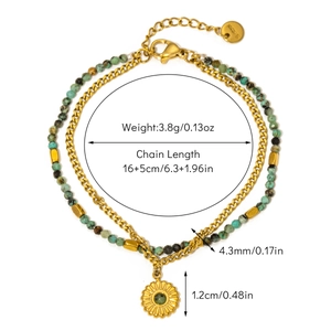 Close-up of double-layer stainless steel bracelet with green stones and sunflower charm