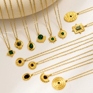 Detailed collection of vintage 18K gold plated stainless steel emerald necklaces