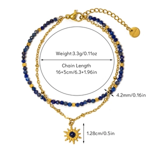 Detail of bohemian gold sun pendant and natural lapis stone beads on layered bracelet