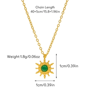 Detail of gold sunburst necklace with green stone showing chain length and pendant size