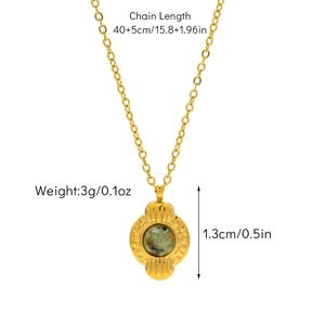 Detail view of a gold necklace with a green stone pendant and 40+5cm size specifications