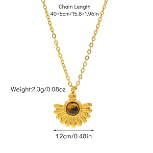Detailed view of sunburst pendant with tiger eye stone on a 18K gold plated chain