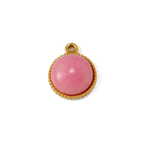 Detailed macro view of a round pink stone pendant with a gold beaded metal border