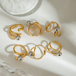 Set of six irregular geometric gold and silver rings with artistic long shadows