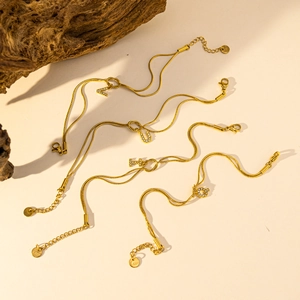 Gouden slangenketting armband met zirkoon initialen en roestvrijstalen knopen