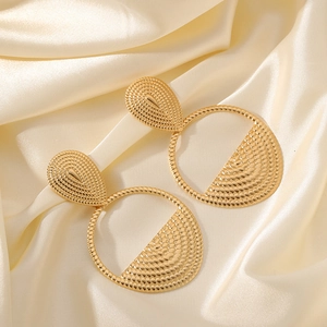 French vintage style gold textured hoop earrings with teardrop stud on champagne silk