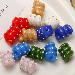 Macro detail of colorful spiral beads with rhinestones for DIY earring craft