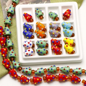 Detailed view of colorful glass Christmas tree beads for DIY jewelry and crafts