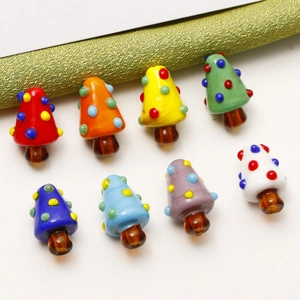 Macro shot of 8 colorful glass mushroom beads with polka dots for DIY jewelry making