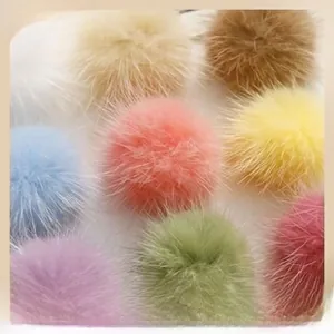 Detail of colorful fluffy faux fur pom poms for DIY crafts and accessories making