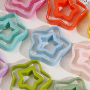 Macro shot of colorful hollow star resin charms for DIY earrings and hair accessories