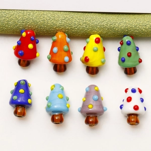 Set of 8 colorful glass Christmas tree beads for DIY jewelry making on white background