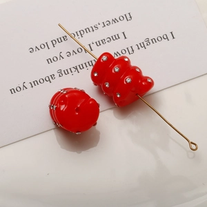 Macro detail of red spiral beads with inlaid rhinestones for DIY jewelry and hair accessories