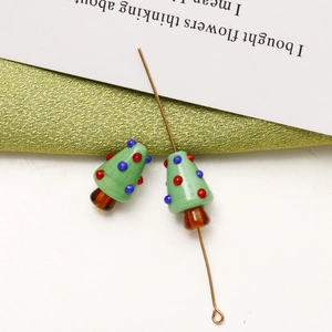 Detail shot of green glass Christmas tree beads for DIY jewelry and festive crafts