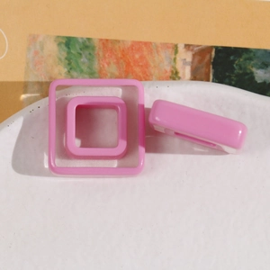 Close-up of pink square resin hollow charms for DIY hair accessories and jewelry