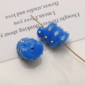 Macro detail of blue wavy resin beads with inlaid rhinestones for DIY jewelry making