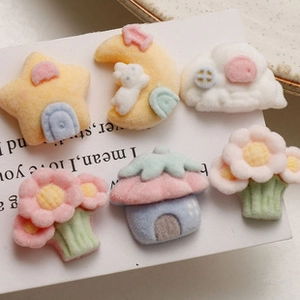 Macro view of six colorful plush star, moon, and rabbit DIY craft resin accessories