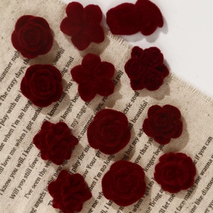 Retro dark red flocked rose and camellia resin accessories on vintage linen background